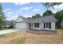 A charming ranch home with white exterior, a two-car garage and manicured front yard at 2470 Hillvale Cir, Lithonia, GA 30058