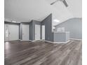 Open living space with high ceilings, laminate flooring, and neutral paint at 2470 Hillvale Cir, Lithonia, GA 30058