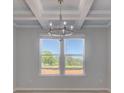 Elegant dining room featuring a stylish chandelier and large windows offering scenic views at 271 Abbotts Crossing Cir, Conyers, GA 30094