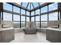 Modern bathroom featuring dual vanities and soaking tub with expansive views at 2828 Peachtree Nw Rd # P 3300, Atlanta, GA 30305