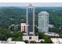 Impressive exterior showing high-rise architecture surrounded by lush greenery, with a pool amenity visible at 2828 Peachtree Nw Rd # P 3300, Atlanta, GA 30305