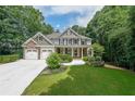Charming two-story home with stone and siding, a well-manicured lawn, and a two car garage at 1403 Benbrooke Circle Northwest Nw Cir, Acworth, GA 30101
