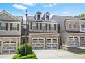 Charming brick townhome with a two-car garage and well-manicured front lawn at 228 Stone Park Dr, Woodstock, GA 30188