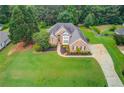 Beautiful brick home showcasing lush lawn and long driveway at 3072 Parks Run, Loganville, GA 30052