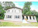 Angle view of painted brick home featuring arched entryways, and traditional windows at 4262 Hambrick Way, Stone Mountain, GA 30083