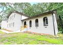 Side view of a painted-brick house with arched entryways and well-maintained landscaping at 4262 Hambrick Way, Stone Mountain, GA 30083