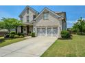 Beautiful two-story home featuring a brick facade, a spacious driveway, and manicured landscaping at 4265 Pleasant Woods Dr, Cumming, GA 30028