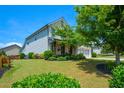 Landscaped front yard showcases a charming home with a manicured lawn at 4265 Pleasant Woods Dr, Cumming, GA 30028