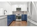 Modern kitchen with stainless steel appliances and stylish blue cabinetry at 2277 Peachtree Ne Rd # 405, Atlanta, GA 30309