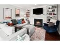 Cozy living room with fireplace, built-in bookshelves, and comfortable seating at 50 Mount Vernon Cir, Atlanta, GA 30338