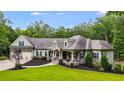 Landscaped front yard, covered porch, and two-car garage of a well-appointed home at 7269 Tyree Rd, Winston, GA 30187