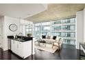 Open living space with city views, modern decor, and hardwood flooring at 923 Peachtree Ne St # 1238, Atlanta, GA 30309