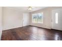 Bright living room featuring hardwood floors, a large window and white walls at 3530 E Ponce De Leon Ave, Scottdale, GA 30079