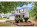 Charming two-story home featuring a well-maintained front yard and attached garage at 6738 Brookfield Way, Douglasville, GA 30134