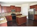 Kitchen with stainless steel appliances, granite counters, tile backsplash, and center island at 1365 Slate Bend Dr, Dacula, GA 30019
