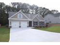Charming one-story home with a spacious driveway and craftsman-style details at 14 Berkten Ct, Hiram, GA 30141