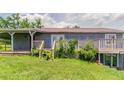 Home backyard with a wooden porch and stair access at 3217 Canterbury Trl, Rex, GA 30273