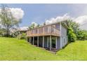 Home's backyard shows a porch and stair access to the basement at 3217 Canterbury Trl, Rex, GA 30273