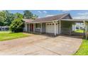Single-story home with large driveway and covered parking area at 3217 Canterbury Trl, Rex, GA 30273
