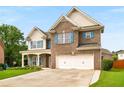 Beautiful two-story brick home featuring a spacious driveway and manicured front lawn at 872 Misty View Ct, Lilburn, GA 30047