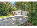 A house with white siding, a front porch, and a long concrete driveway at 3000 Fern Valley Sw Dr, Marietta, GA 30008