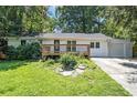 Charming single-story home featuring a inviting front porch and a well-maintained lawn at 3000 Fern Valley Sw Dr, Marietta, GA 30008