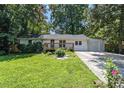 Charming single-story home featuring a inviting front porch and a well-maintained lawn at 3000 Fern Valley Sw Dr, Marietta, GA 30008