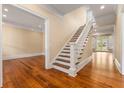 Elegant foyer with hardwood floors and a staircase leading to the upper level at 3786 Turnberry Ct, Duluth, GA 30096