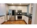 Well-equipped kitchen with stainless steel appliances, white cabinets, and stylish backsplash at 793 Inman Mews Ne Dr, Atlanta, GA 30307