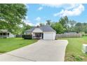 Single-story house with a green lawn and driveway leading to an attached one-car garage at 15 Echota Ne Rd, Cartersville, GA 30121