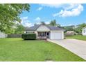 A cozy single-story home with lush green lawn and a driveway leading to a one car garage at 15 Echota Ne Rd, Cartersville, GA 30121