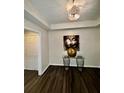 Inviting entryway featuring dark wood floors, stylish lighting, and decorative accents at 220 Renaissance Ne Pkwy # 2220, Atlanta, GA 30308