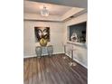 Modern living space with bar seating, attractive lighting, and hardwood floors at 220 Renaissance Ne Pkwy # 2220, Atlanta, GA 30308