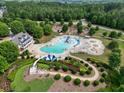 Aerial view of community pool with slides and recreational areas surrounded by lush green landscape at 25 Nunnally Pl, Villa Rica, GA 30180