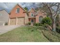 Two-story brick home boasting an attached two-car garage, inviting entrance, and manicured lawn at 25 Nunnally Pl, Villa Rica, GA 30180