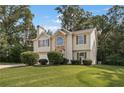 Beautiful home with manicured lawn, a two-car garage, and a stone-accented facade at 5960 Castlegate Dr, Douglasville, GA 30135