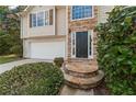 Close-up view of the stone steps leading up to the home's dark-colored front door at 5960 Castlegate Dr, Douglasville, GA 30135