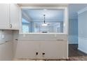 Open kitchen featuring a pass through window with views of the living area and fireplace at 402 John Tate Nw Rd, Acworth, GA 30102