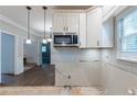 Kitchen featuring modern appliances and classic white cabinetry awaiting your design and renovation at 402 John Tate Nw Rd, Acworth, GA 30102