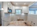 Kitchen with unfinished floors and exposed walls awaiting your design and renovation at 402 John Tate Nw Rd, Acworth, GA 30102