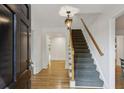 Bright foyer with hardwood floors, staircase, and an elegant light fixture, creating a welcoming entrance at , Dunwoody, GA 30338