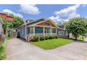 A beautiful blue home with a covered front porch, green lawn, and inviting curb appeal at 496 Rankin Ne St, Atlanta, GA 30308