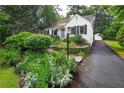 Beautifully landscaped front yard and driveway leading to detached garage at 657 E Paces Ferry Ne Rd, Atlanta, GA 30305