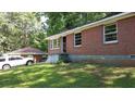 Single-story brick home with a carport providing convenient covered parking and a well-kept lawn at 2545 Saint Patrick Se St, Atlanta, GA 30317
