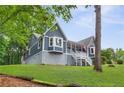 Beautiful home featuring a cozy porch, bay window, and well-manicured lawn offers inviting outdoor living space at 4002 Joshua Ln, Douglasville, GA 30135