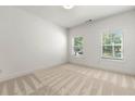 Bright and airy bedroom with neutral carpet, two windows, and ample natural light at 2140 Colvin Nw Ct, Atlanta, GA 30318
