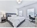 Bright bedroom with a plush bed and ample natural light from two windows at 2140 Colvin Nw Ct, Atlanta, GA 30318