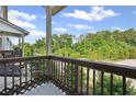 Enjoy the outdoors from this balcony with views of mature trees and blue skies at 3116 Quantum Ln, Atlanta, GA 30341