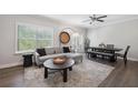 Bright living room with hardwood floors, plush gray sofa, and natural light from large window at 3116 Quantum Ln, Atlanta, GA 30341