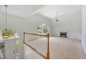 Bright living room with large windows, a vaulted ceiling, fireplace and neutral carpet at 5137 Allison Way, Sugar Hill, GA 30518